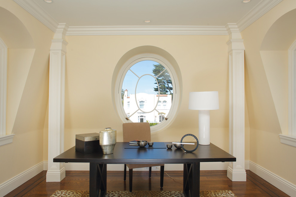 Home office - contemporary freestanding desk dark wood floor home office idea in San Francisco with yellow walls