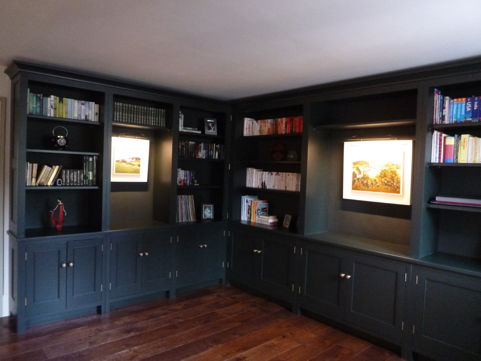 Photo of a medium sized traditional study in Other with green walls, dark hardwood flooring, a standard fireplace and a stone fireplace surround.
