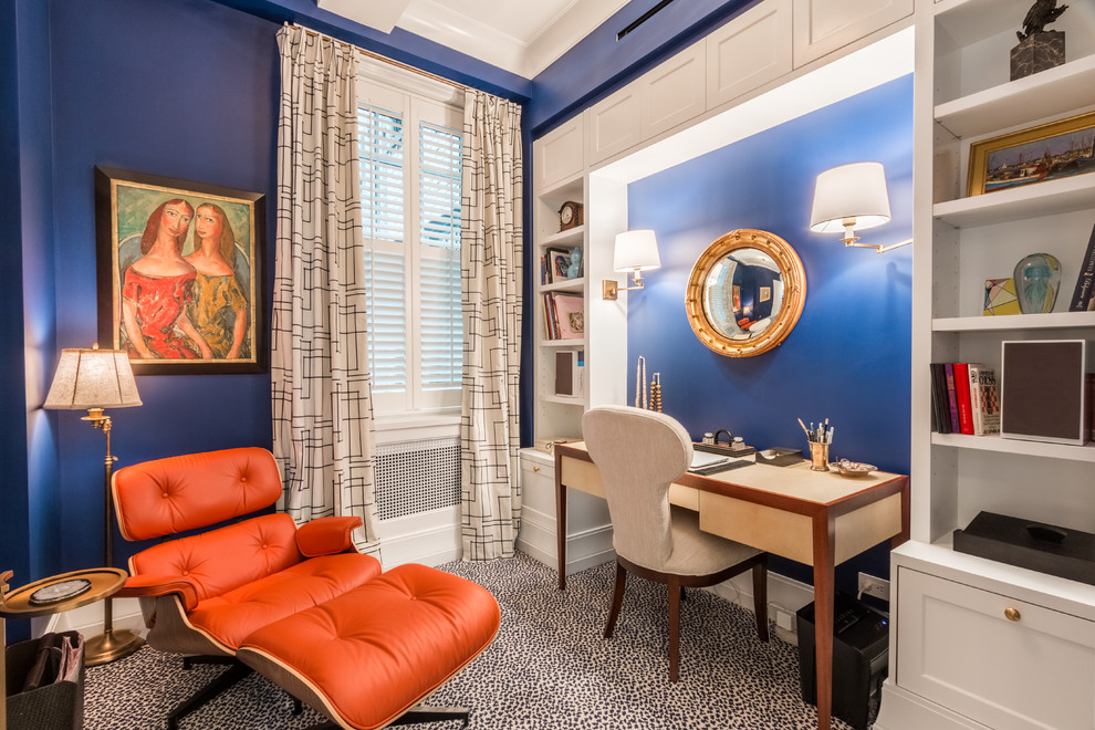 Photo of a classic study in New York with blue walls and carpet.