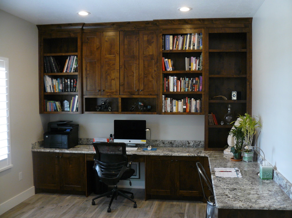 ソルトレイクシティにある広いコンテンポラリースタイルのおしゃれなホームオフィス・書斎 (グレーの壁、クッションフロア、暖炉なし、造り付け机、茶色い床) の写真