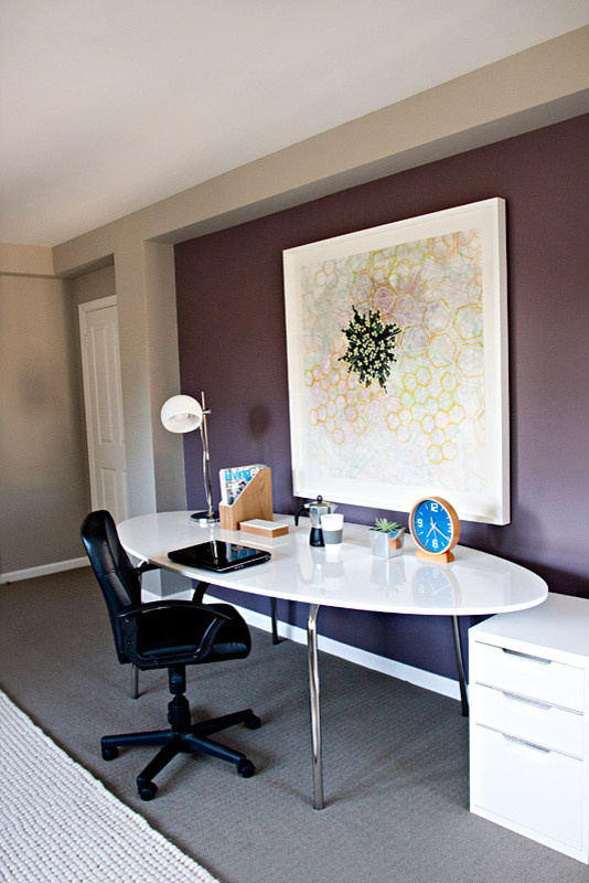 This is an example of a large modern study in Los Angeles with purple walls, carpet, no fireplace, a freestanding desk and grey floors.