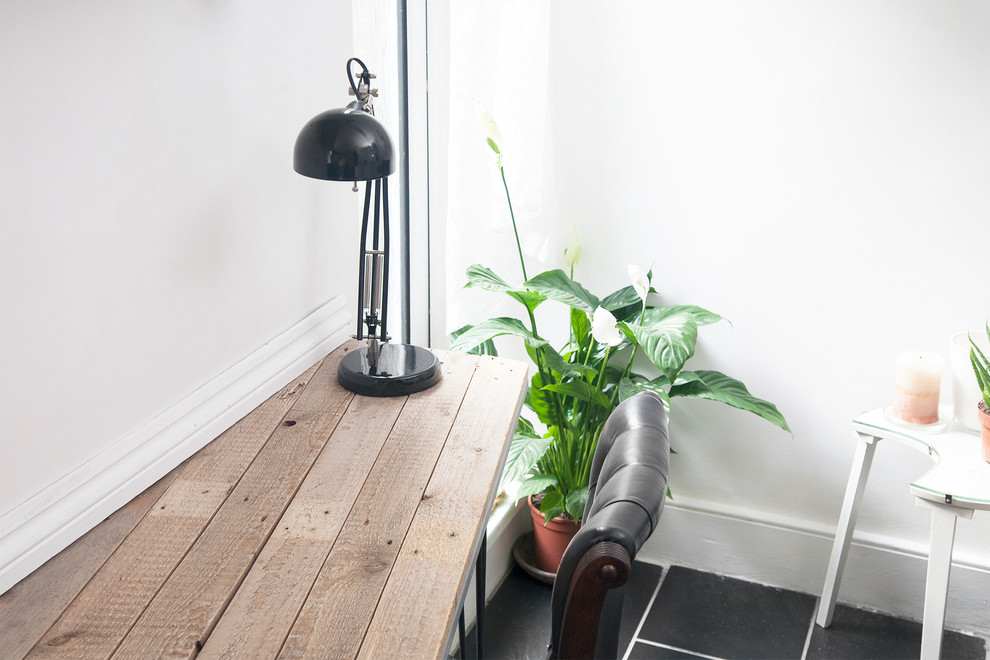 Kleines Eklektisches Arbeitszimmer ohne Kamin mit weißer Wandfarbe, Keramikboden, Einbau-Schreibtisch und schwarzem Boden in London