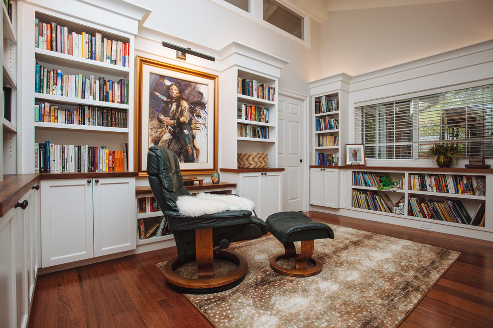 This is an example of a large classic home office in Portland with a reading nook, dark hardwood flooring, brown floors, white walls and no fireplace.
