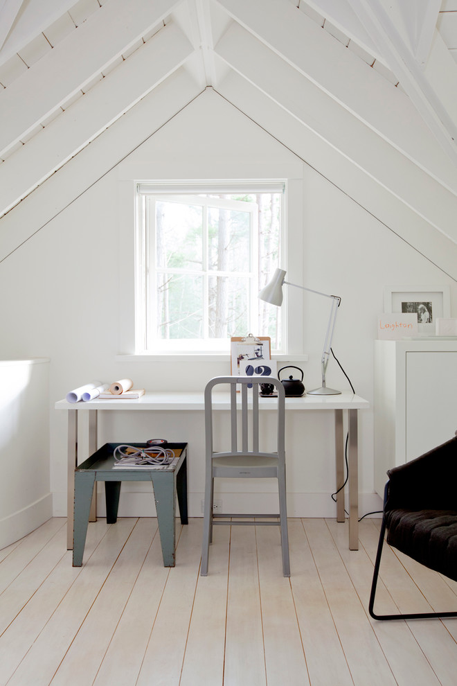 Inredning av ett minimalistiskt arbetsrum, med vita väggar och ljust trägolv