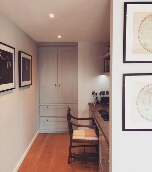 Photo of a large contemporary study in London with grey walls, light hardwood flooring and a built-in desk.