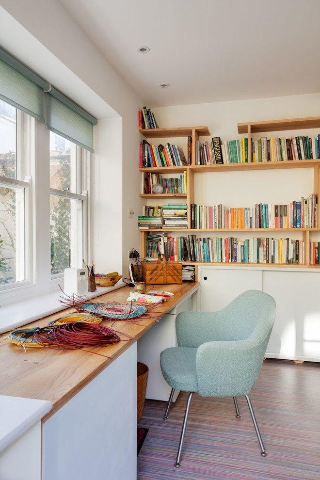 Danish built-in desk home office photo in Sussex with white walls