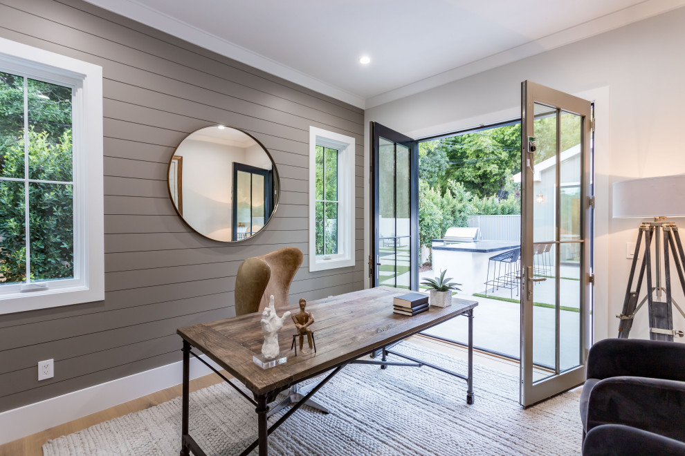 Photo of a medium sized classic study in Los Angeles with grey walls, light hardwood flooring, a freestanding desk, a drop ceiling and panelled walls.