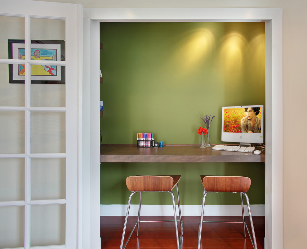 Trendy brown floor home office photo in Orange County with white walls