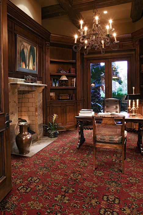Ejemplo de despacho clásico de tamaño medio con moqueta, paredes marrones, todas las chimeneas, marco de chimenea de ladrillo y suelo rojo