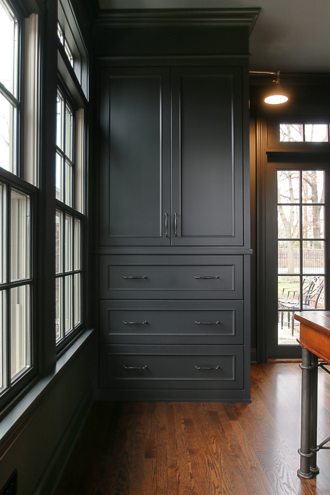 Elegant freestanding desk dark wood floor study room photo in Chicago with gray walls