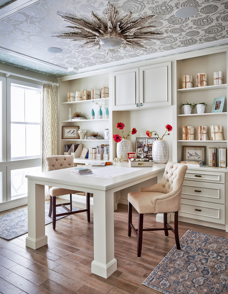 Example of a classic built-in desk medium tone wood floor home office design in Denver