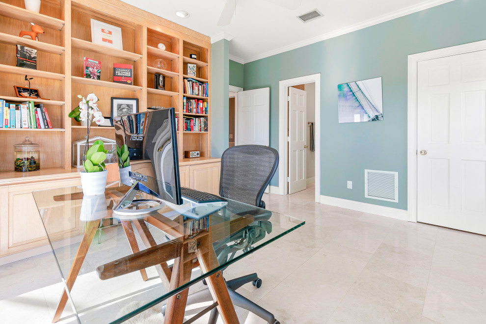 Mid-sized danish freestanding desk marble floor and beige floor home office library photo in Jacksonville with green walls