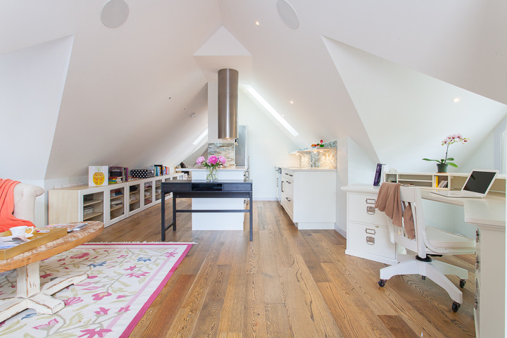 Ejemplo de despacho de estilo de casa de campo pequeño con paredes blancas y suelo de madera clara