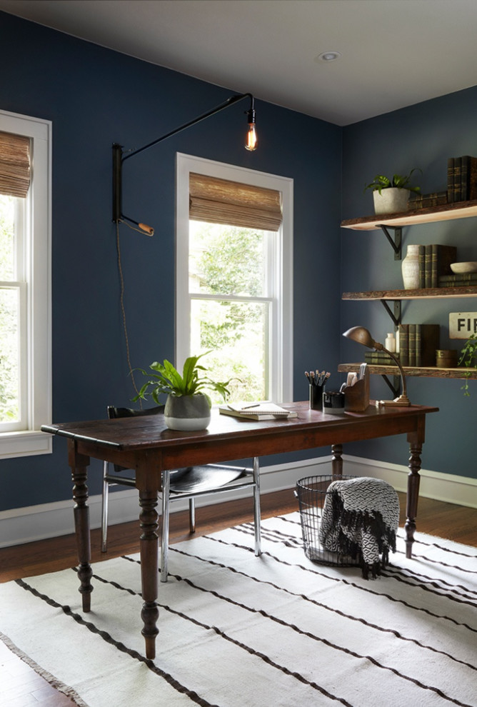 На фото: кабинет в стиле неоклассика (современная классика) с синими стенами, паркетным полом среднего тона, отдельно стоящим рабочим столом и коричневым полом