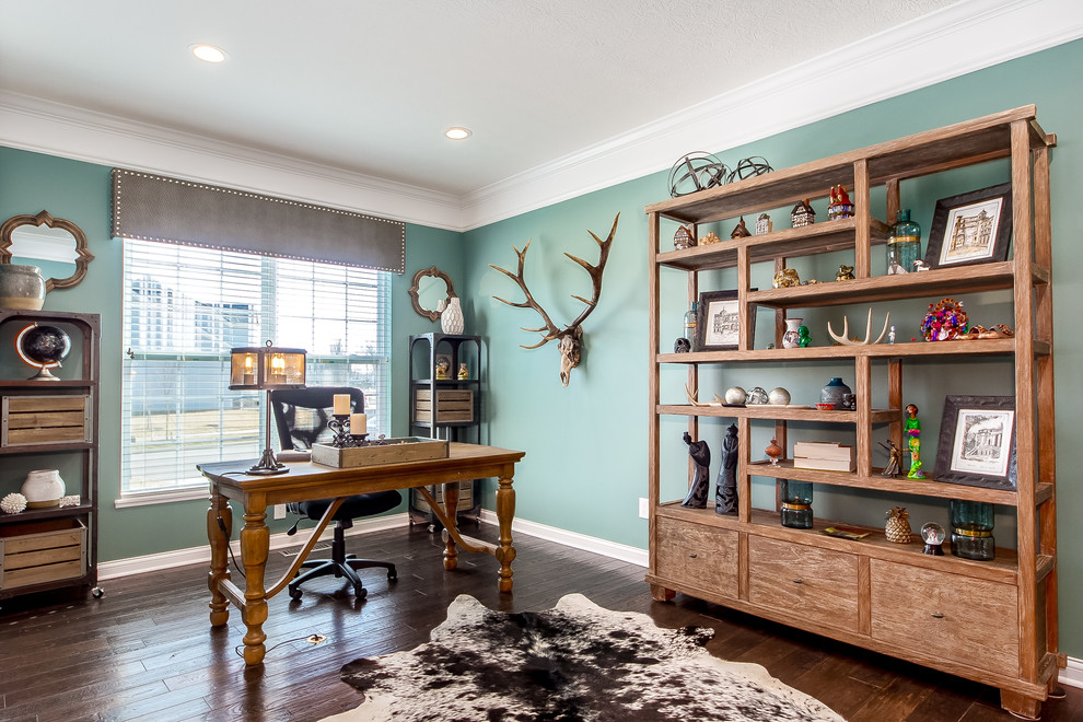 This is an example of a medium sized rustic home office in Columbus with green walls, dark hardwood flooring, no fireplace, a freestanding desk and brown floors.