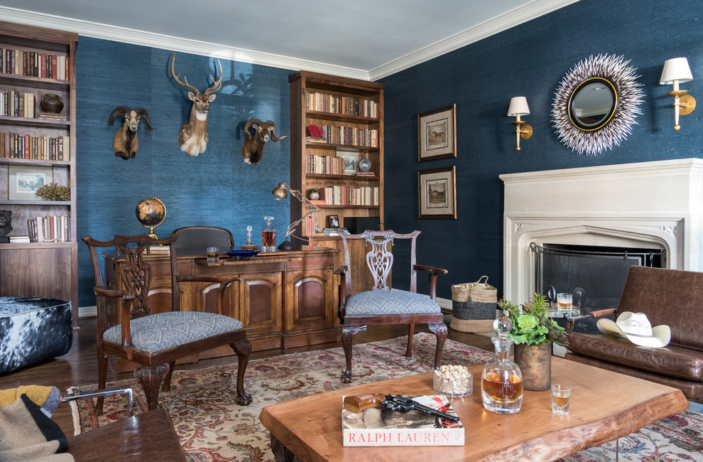 Inspiration for a large eclectic study in Dallas with blue walls, dark hardwood flooring, a standard fireplace, a stone fireplace surround, a freestanding desk and brown floors.