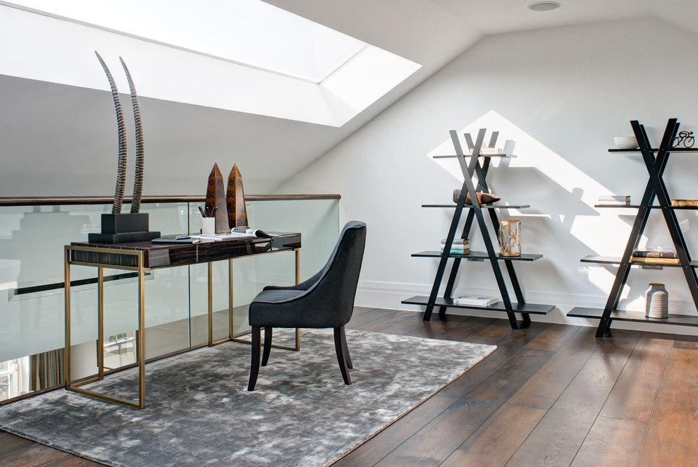 This is an example of a contemporary study in Surrey with white walls, dark hardwood flooring and a freestanding desk.