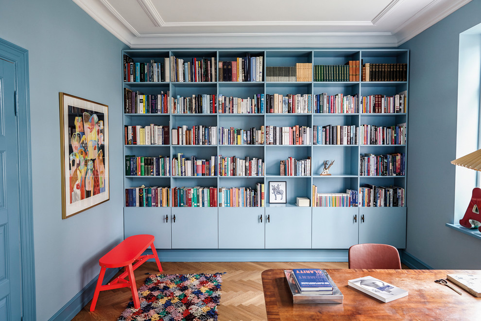 Study room - large mid-century modern freestanding desk medium tone wood floor study room idea in Copenhagen with blue walls and no fireplace