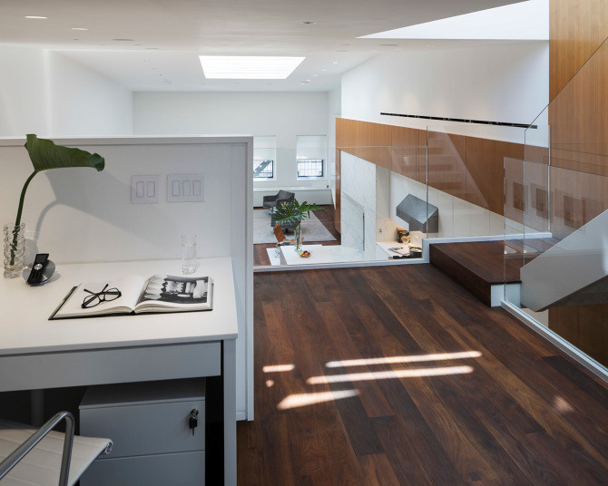 Ejemplo de despacho contemporáneo grande sin chimenea con paredes blancas, suelo de madera en tonos medios y escritorio independiente