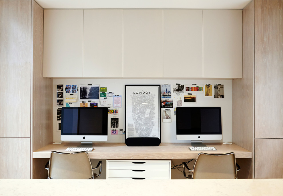 Inspiration for a contemporary study in London with light hardwood flooring and a built-in desk.