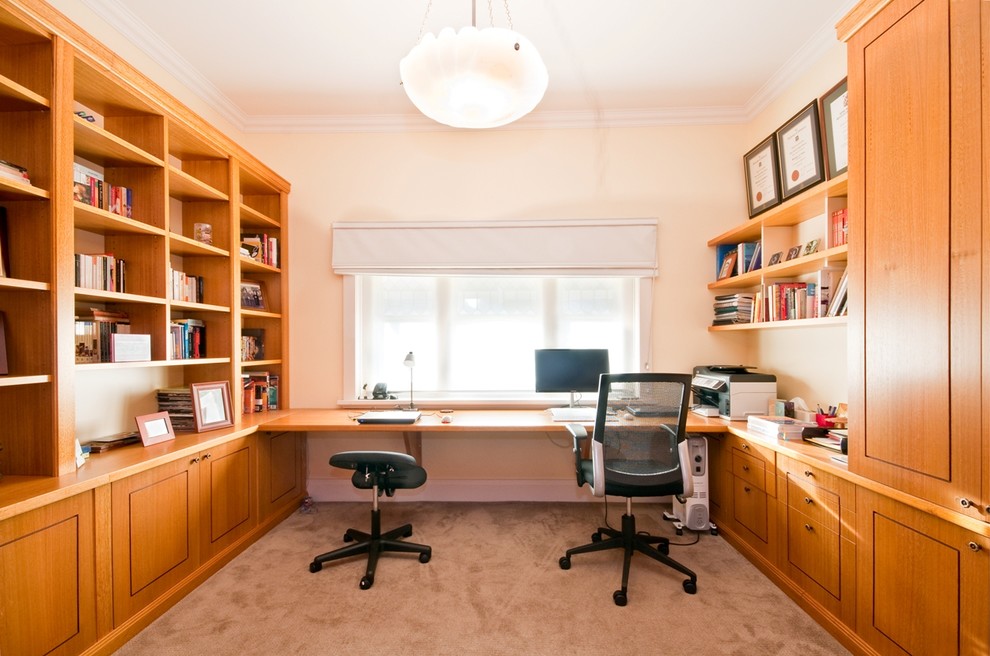 Example of a huge transitional built-in desk carpeted study room design in Melbourne with white walls and no fireplace