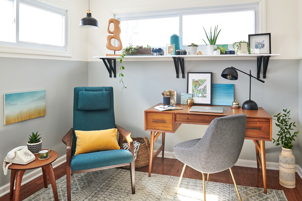 Small trendy freestanding desk dark wood floor and brown floor study room photo in New York with gray walls