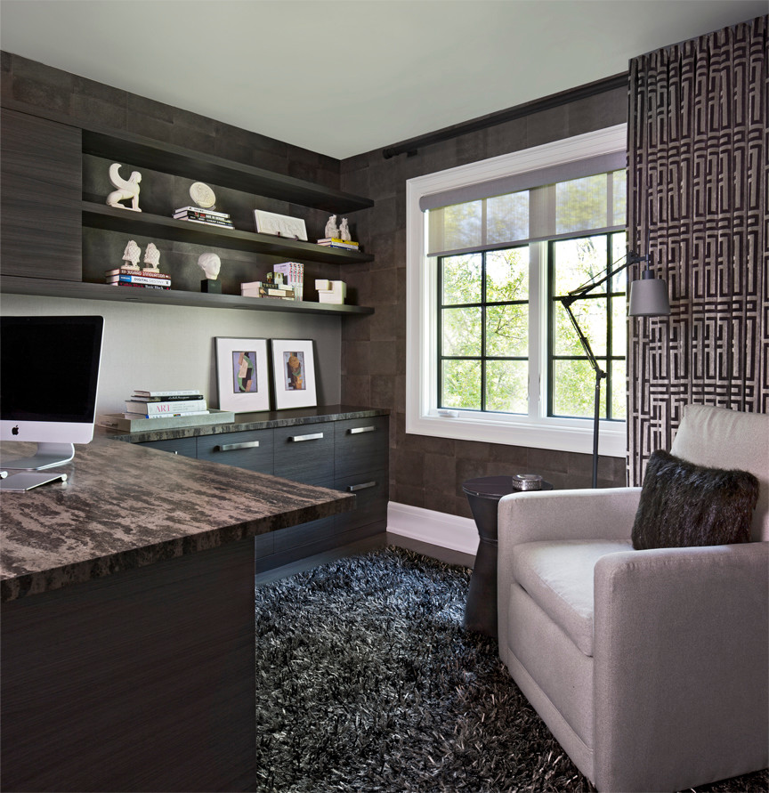 This is an example of a medium sized contemporary study in Detroit with brown walls, dark hardwood flooring, a built-in desk and brown floors.