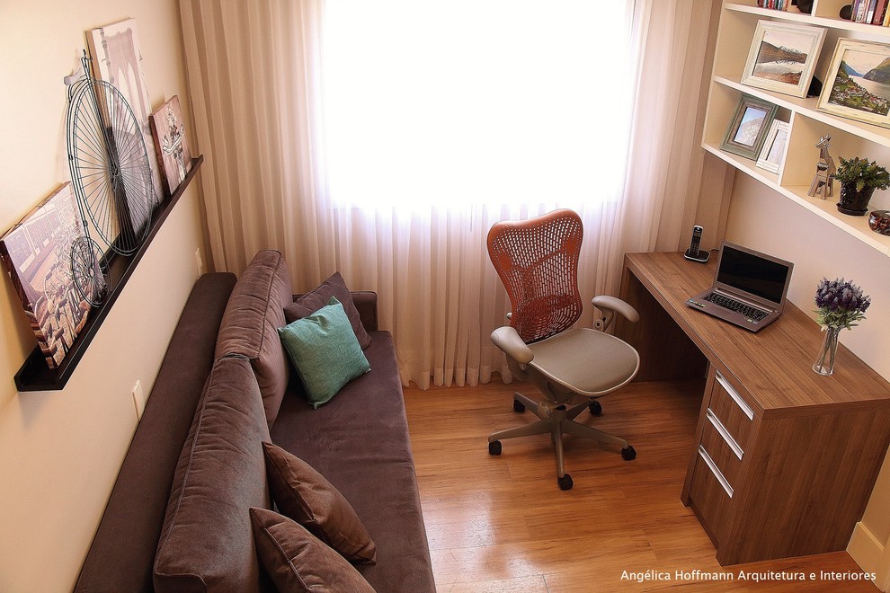 Small trendy freestanding desk dark wood floor and brown floor study room photo in Other with brown walls