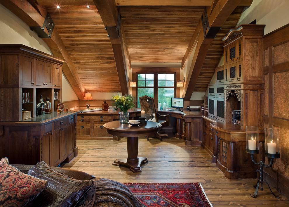 Inspiration for a large rustic study in Vancouver with beige walls, medium hardwood flooring and a built-in desk.