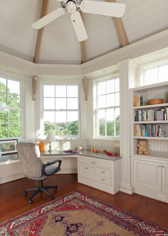 Example of a mid-sized classic built-in desk medium tone wood floor and brown floor study room design in San Francisco with white walls and no fireplace
