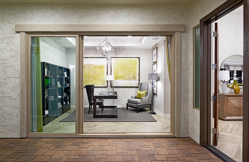 This is an example of a contemporary home office in Denver with a freestanding desk.