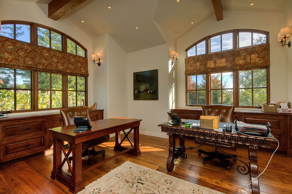 Photo of a classic home office in San Francisco with beige walls, medium hardwood flooring and a freestanding desk.