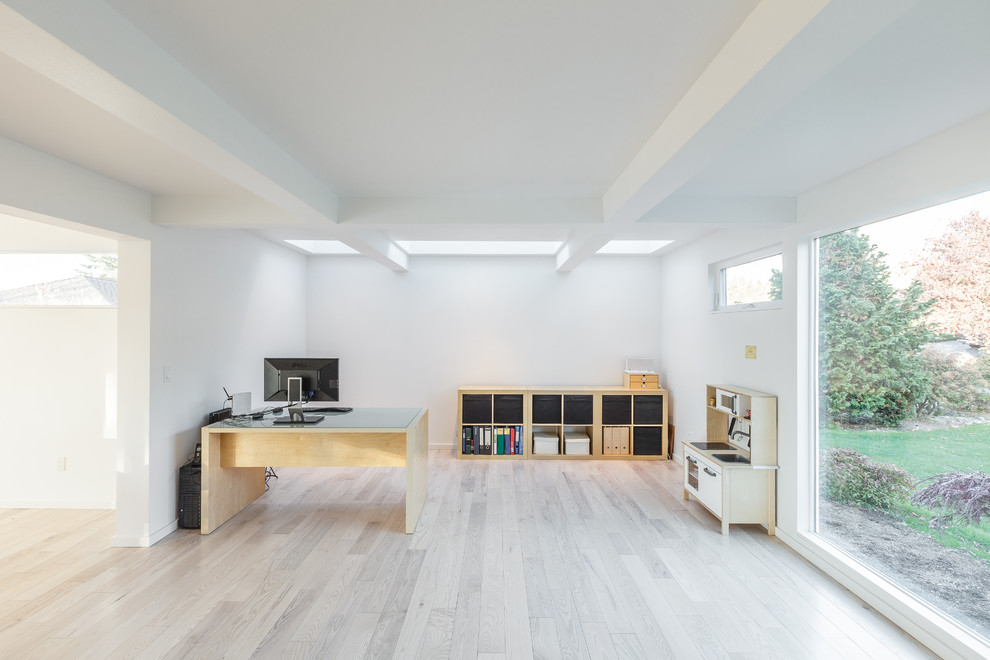 Inspiration for a large contemporary freestanding desk light wood floor study room remodel in Seattle with white walls