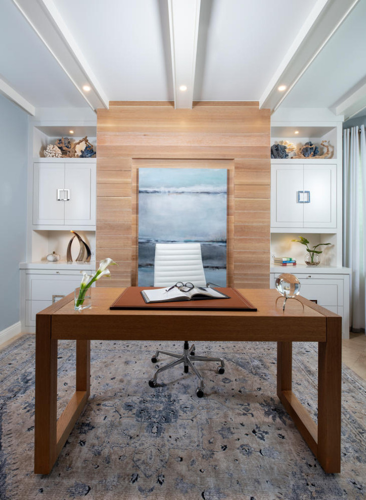 Aménagement d'un grand bureau bord de mer en bois avec un mur bleu, un sol en travertin, un bureau indépendant, un sol beige et poutres apparentes.