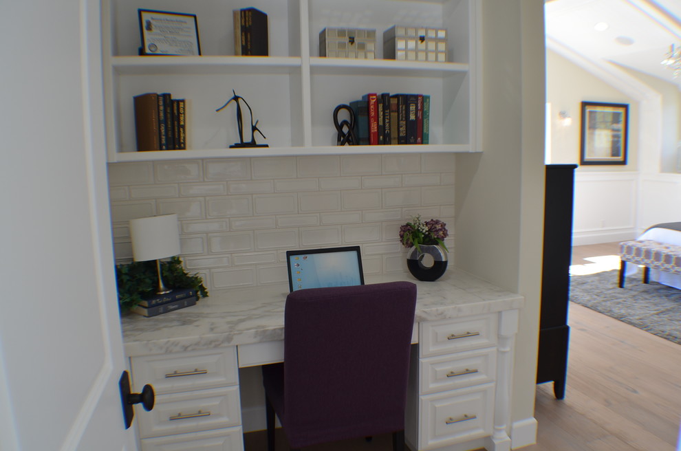 Idée de décoration pour un petit bureau tradition avec un mur beige, un sol en bois brun, aucune cheminée, un bureau intégré et un sol marron.