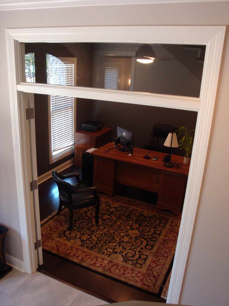 Medium sized classic study in Jackson with grey walls, medium hardwood flooring, no fireplace and a freestanding desk.