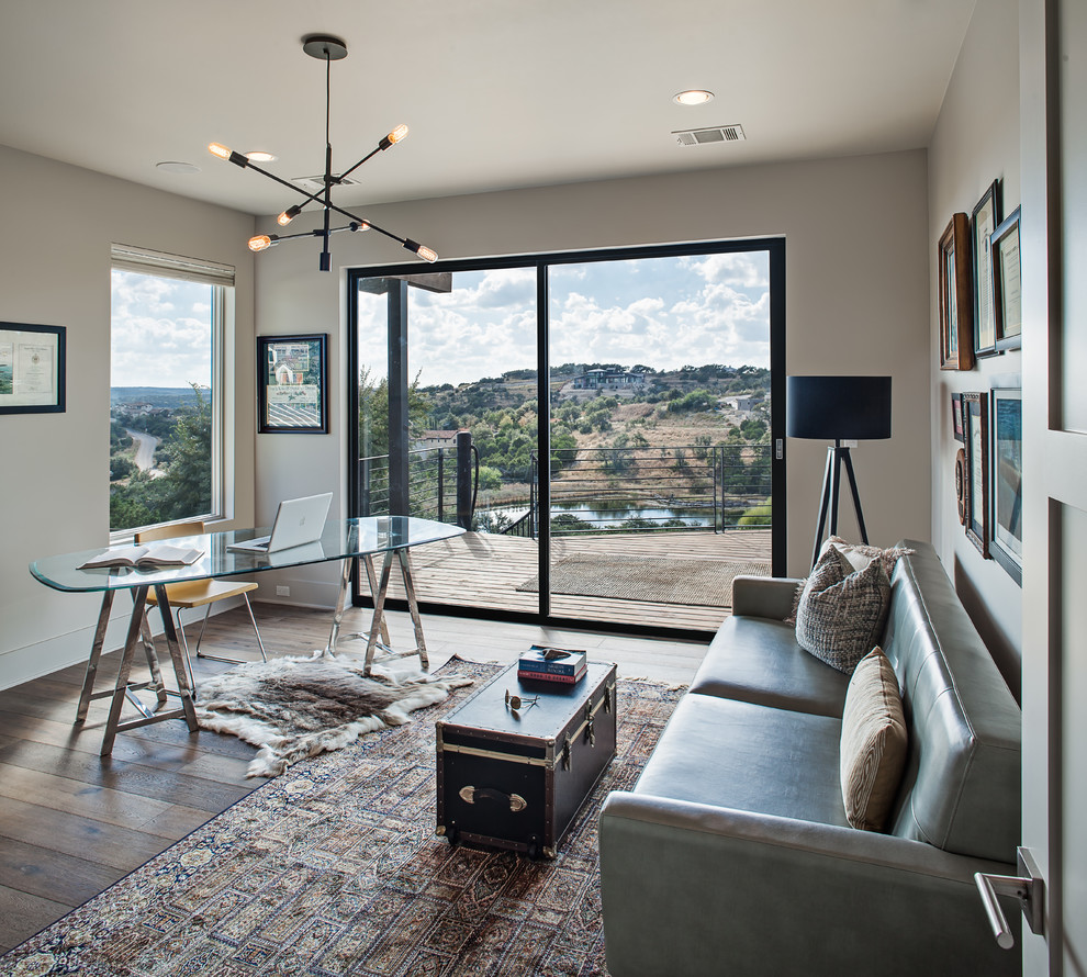 Inspiration for a mid-sized transitional freestanding desk dark wood floor and brown floor study room remodel in Austin with beige walls and no fireplace