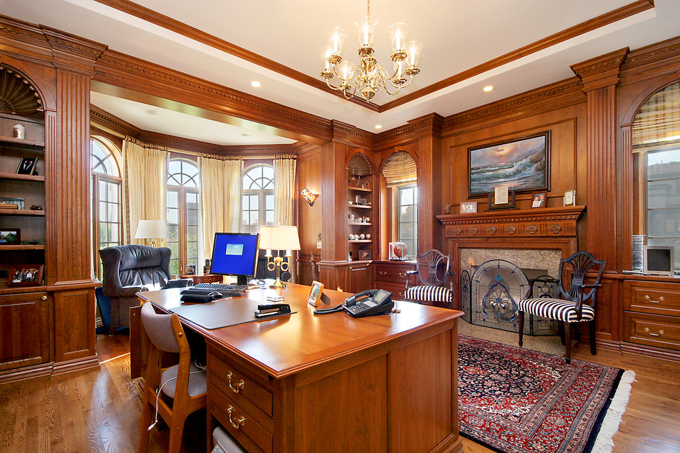 Inspiration for a large timeless freestanding desk medium tone wood floor study room remodel in Chicago with brown walls, a standard fireplace and a tile fireplace