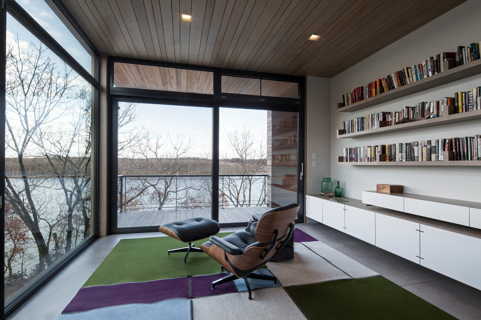 Home office - contemporary built-in desk home office idea in New York with white walls