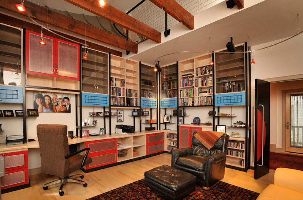 Inspiration for a large contemporary craft room in Other with white walls, light hardwood flooring and a built-in desk.
