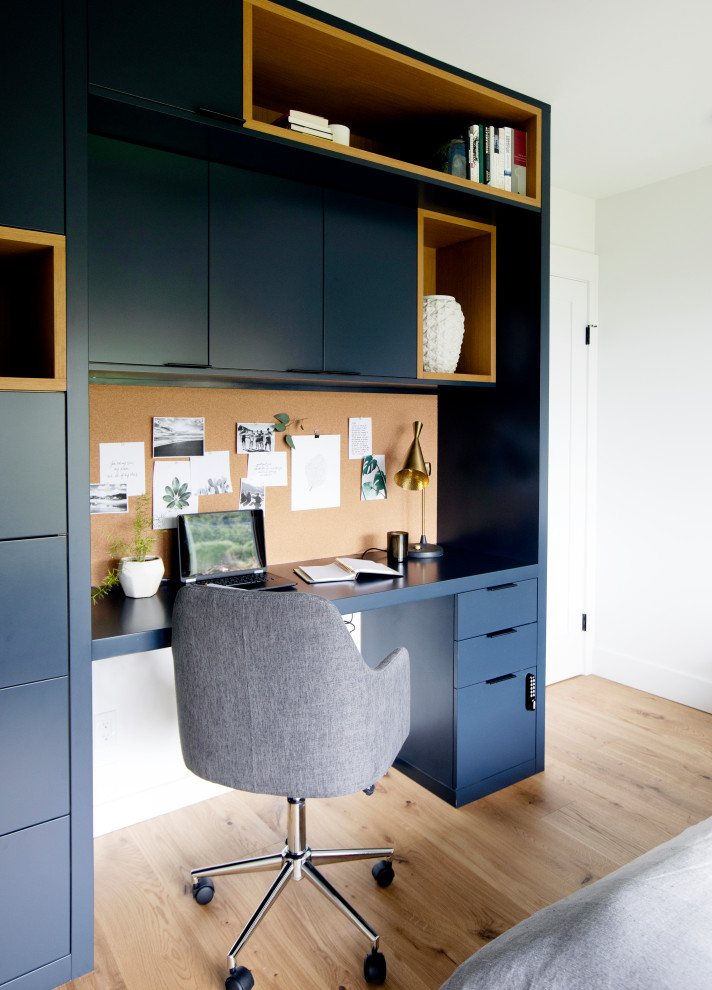 Esempio di un ufficio minimal di medie dimensioni con pavimento in legno massello medio e scrivania incassata