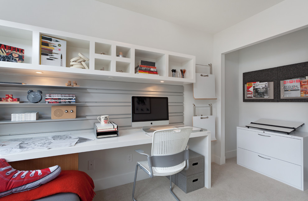 This is an example of a contemporary home office in Vancouver with white walls, carpet and a built-in desk.