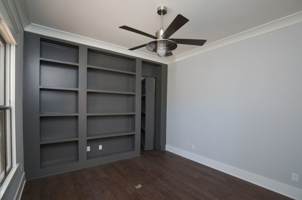 This is an example of a medium sized classic study in Raleigh with grey walls, medium hardwood flooring, brown floors and no fireplace.