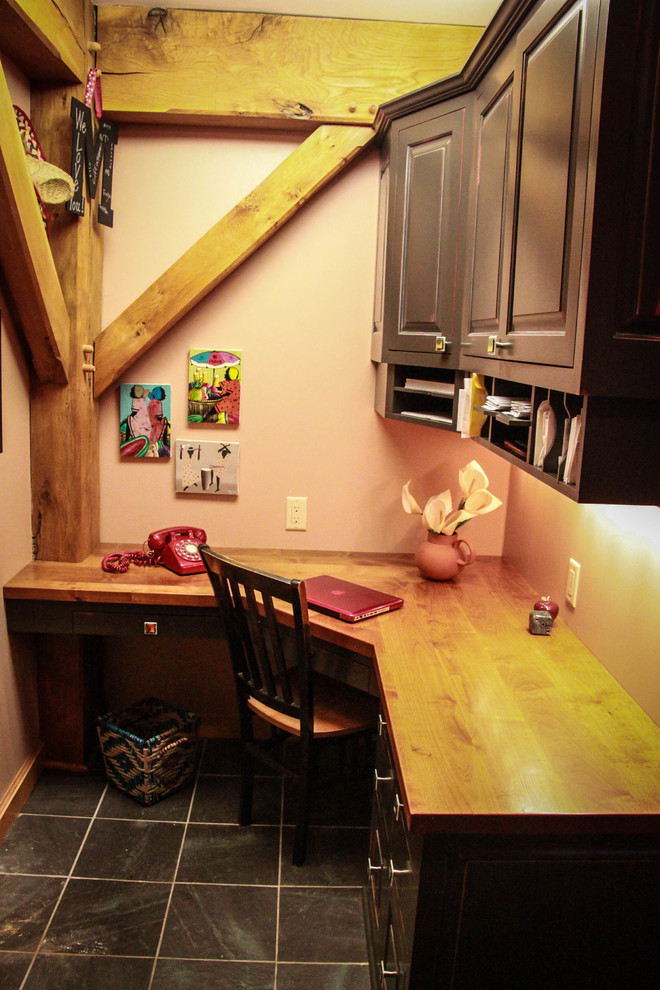 На фото: маленькая домашняя мастерская в стиле рустика с бежевыми стенами, полом из сланца и встроенным рабочим столом для на участке и в саду