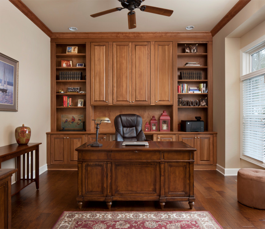 Photo of a large traditional study in Other with beige walls, medium hardwood flooring, no fireplace and a freestanding desk.