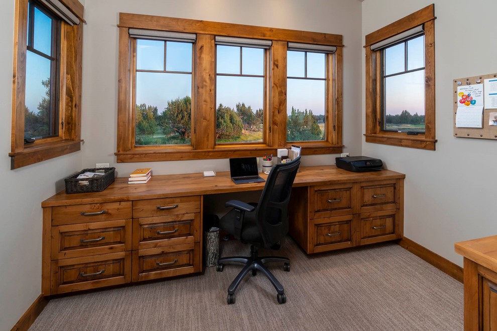 Inspiration for a medium sized rustic home office in Other with beige walls, carpet, a built-in desk and beige floors.