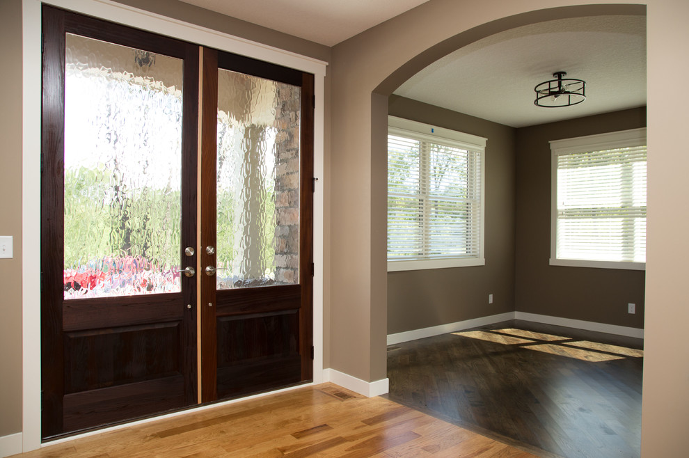 Inspiration for a classic study in Minneapolis with brown walls and dark hardwood flooring.