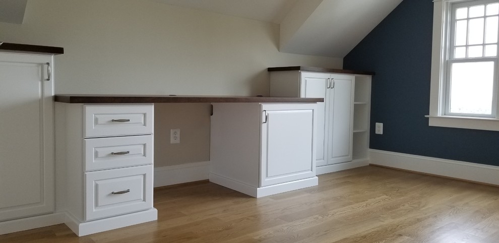 Inspiration for a large timeless built-in desk medium tone wood floor and brown floor home office remodel in DC Metro with yellow walls