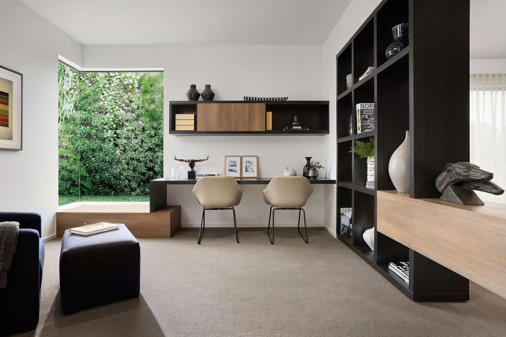 Großes Modernes Arbeitszimmer mit Arbeitsplatz, weißer Wandfarbe, Teppichboden, Einbau-Schreibtisch und grauem Boden in Melbourne