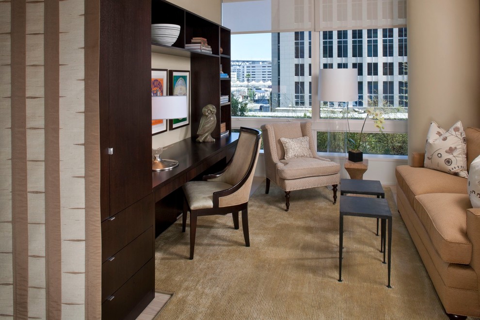 Example of a classic built-in desk carpeted home office design in Hawaii with beige walls